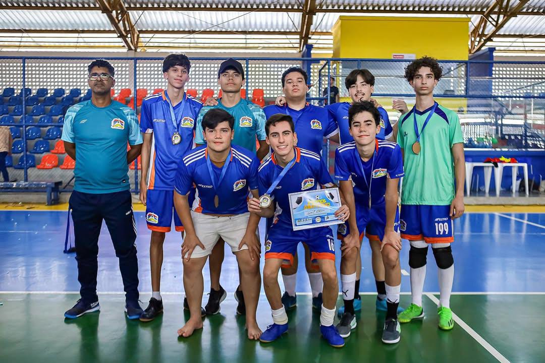Time esportivo da Escola Alternativa com medalhas após campeonato